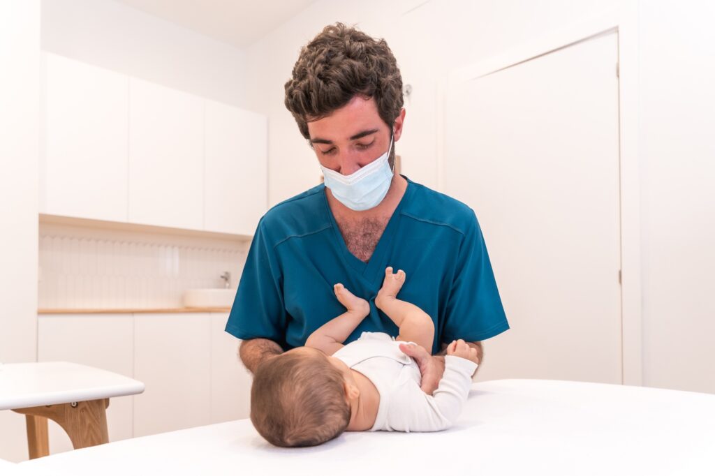 Doctor checking up a baby lying down in a clinic