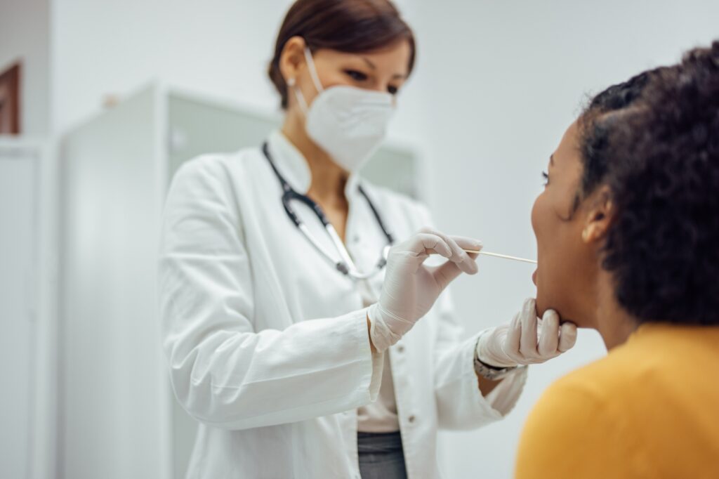 Woman having her throat examined by a doctor.
